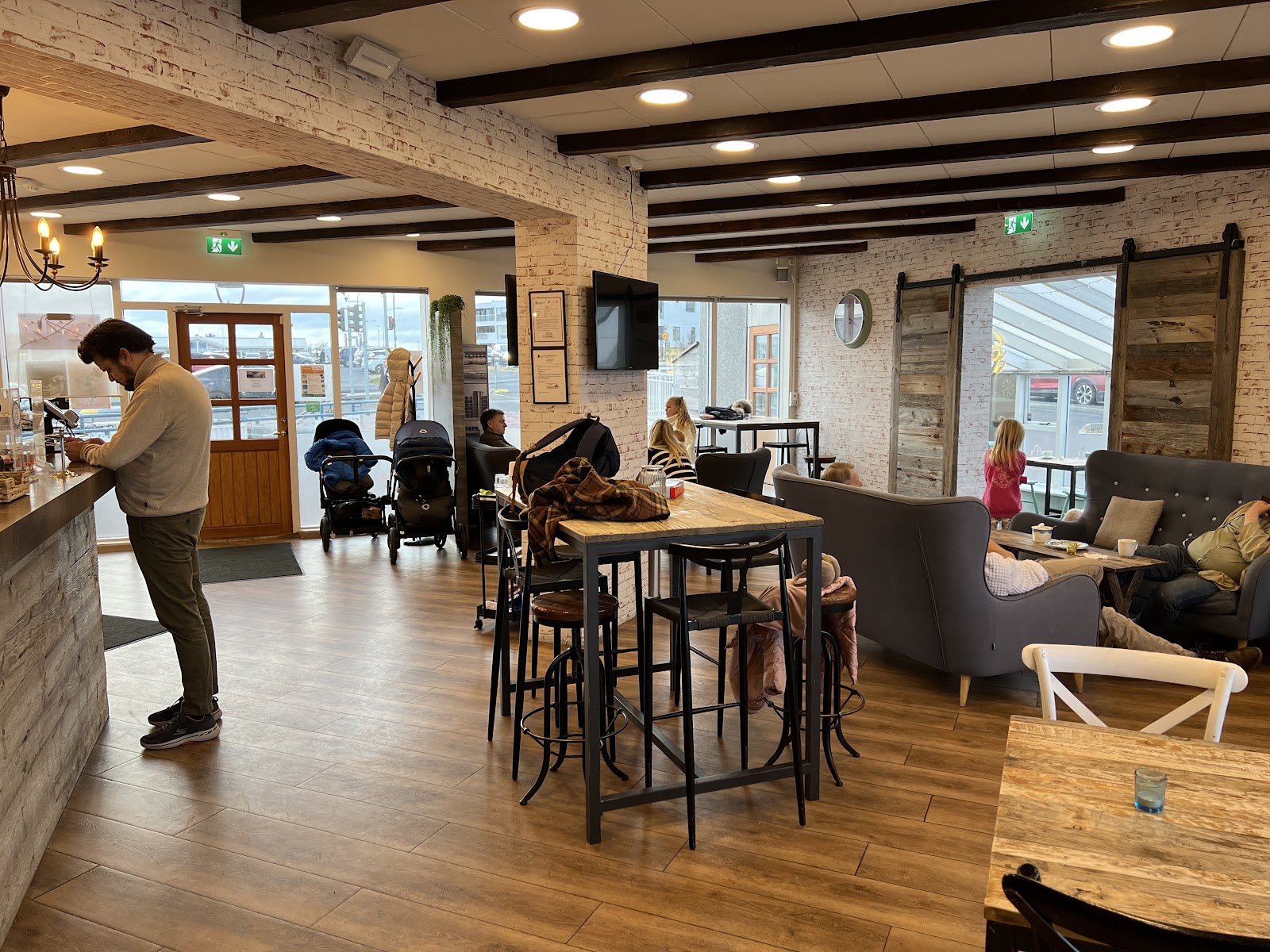 Cosy interior of Arna Ís og Kaffi with sofas and warm light